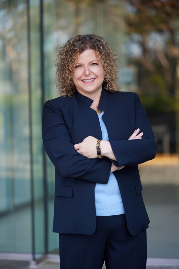 Business headshot of a woman in a navy suit photographed outside a downtown Los Angeles office