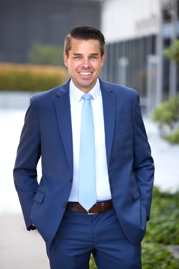 Business headshot of a man in a blue suit photographed outdoors in Los Angeles