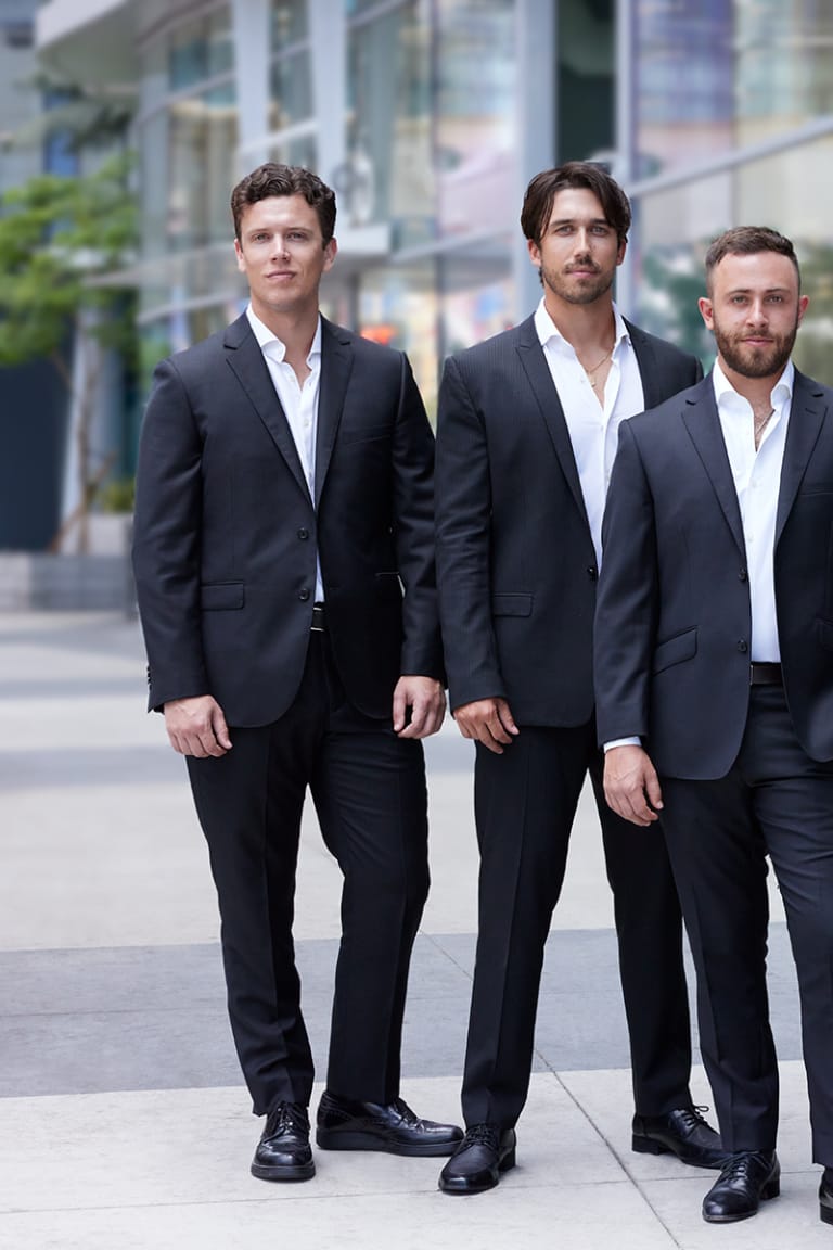 Team headshot of three colleagues in suits photographed on location in Los Angeles