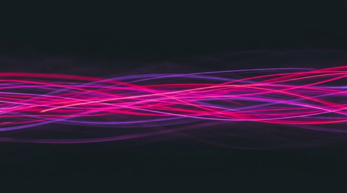 Streaks of magenta light in motion